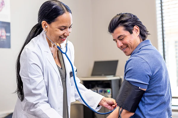 Doctor taking patient blood pressure