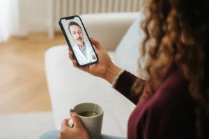 Woman using smartphone for virtual doctor visit